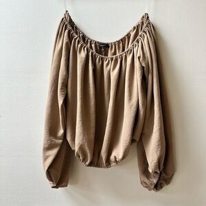 Flowy off-the-shoulder top with billowy sleeves for an effortless and chic look.